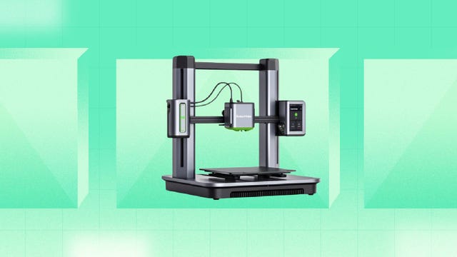 An Anker 3D printer against a green background.