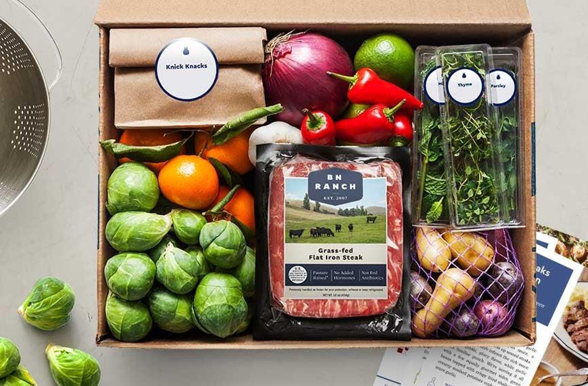 box of food items from blue apron, including meat, veggies, potatoes and herbs