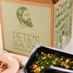 box of pete's food with meals in front