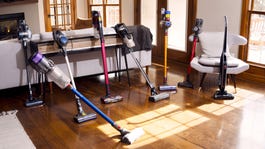 A selection of cordless stick vacuums on a hardwood floor